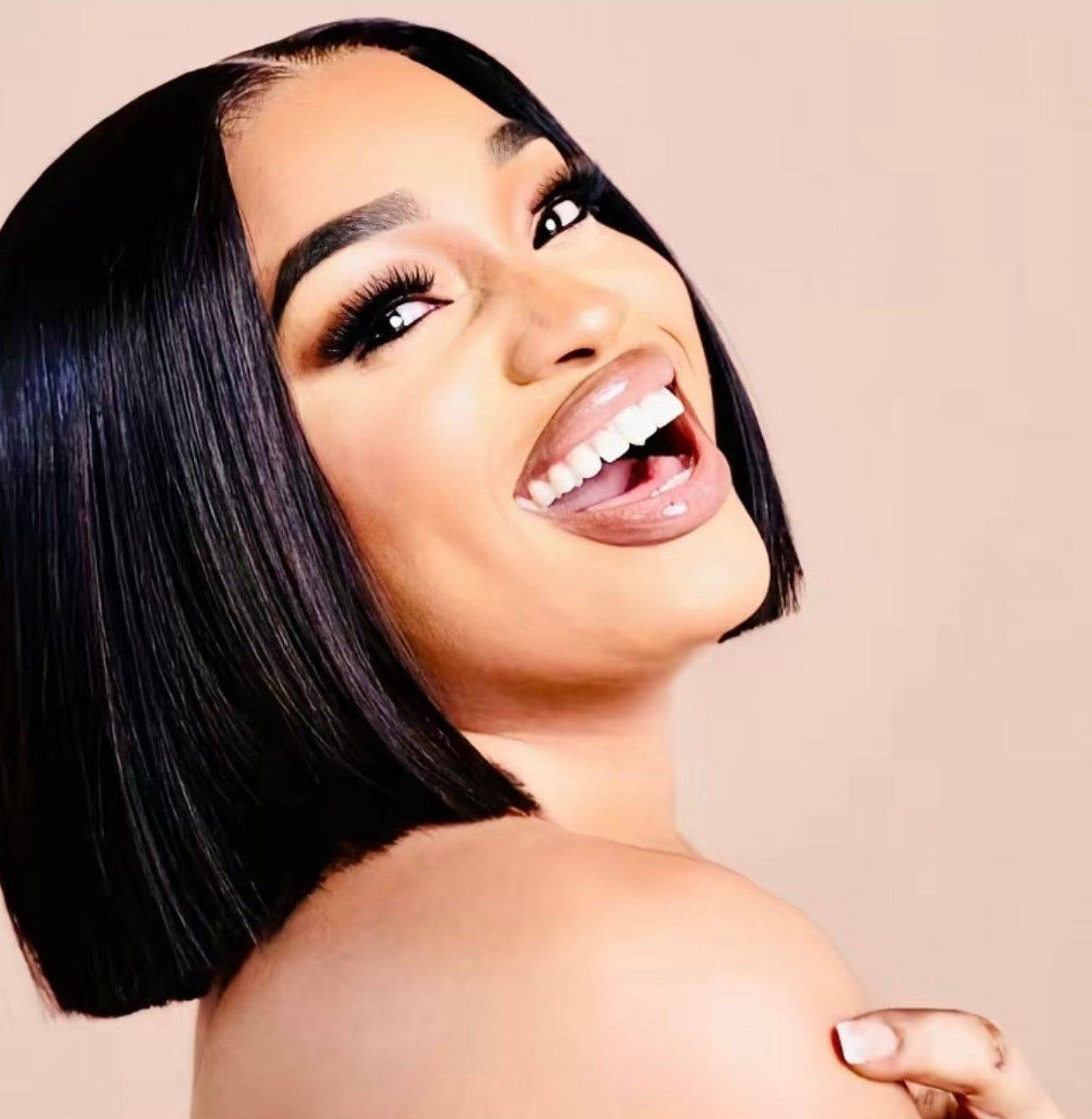 Woman with a short black hairstyle on a beige background