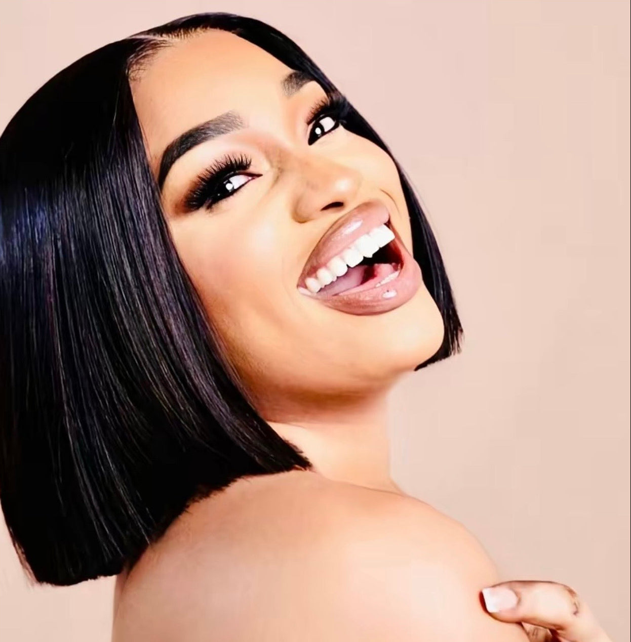 Woman with a short black hairstyle on a beige background